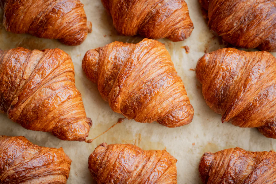 A tray of freshly baked croissants, golden and flaky